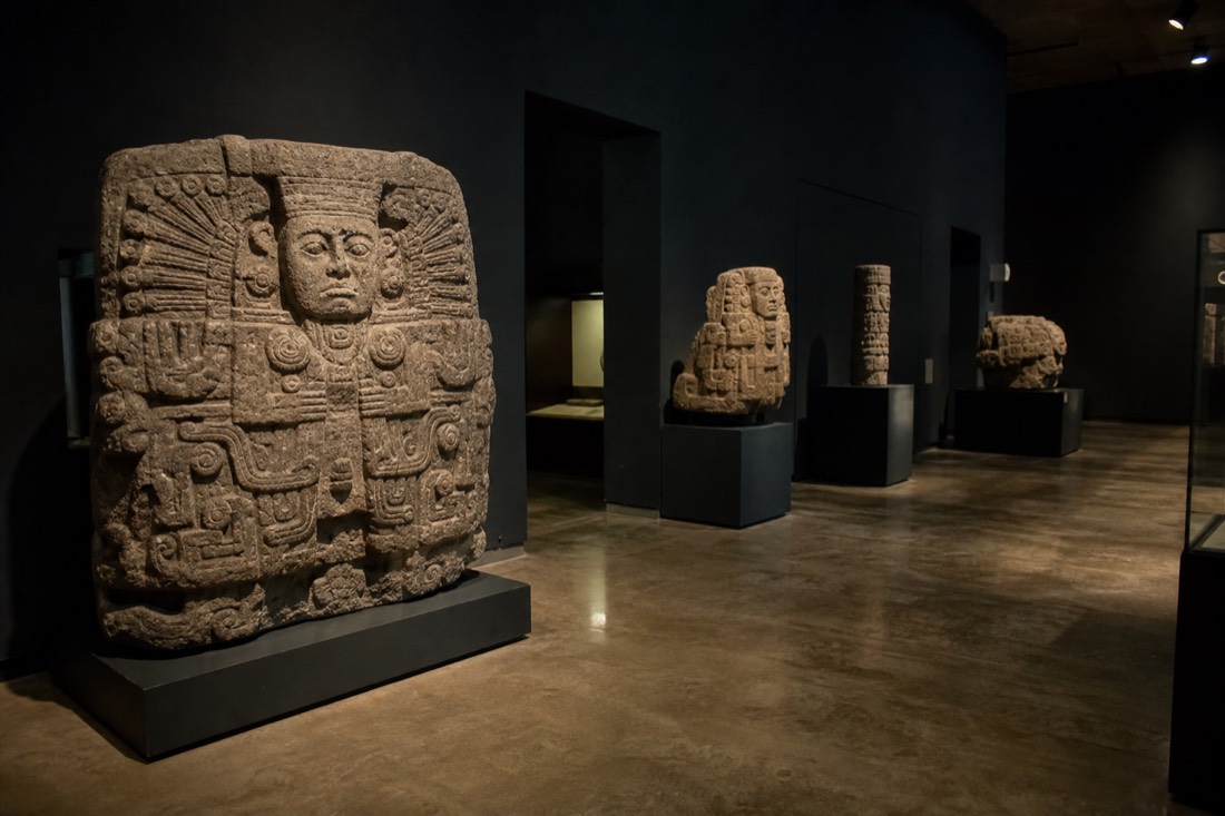 A museum hall displaying carved stone artefacts from Teotihuacan