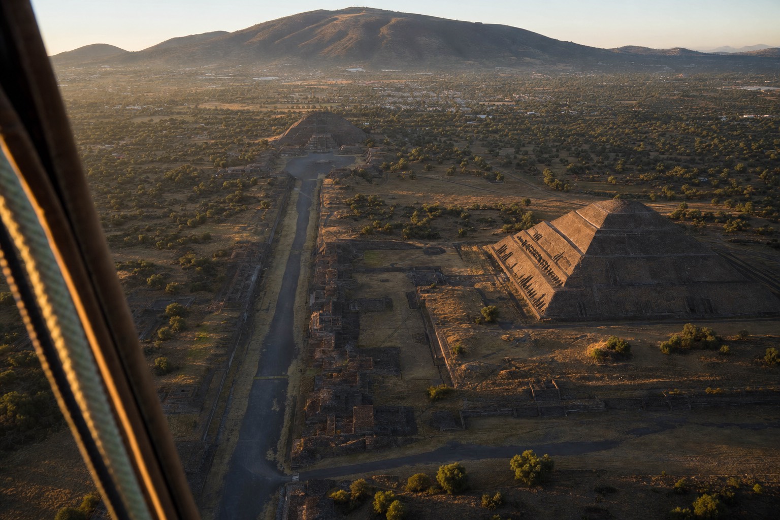 The Avenue of the Dead and both Teotihuacan pyramids seen obliquely from a hot air balloon at sunrise