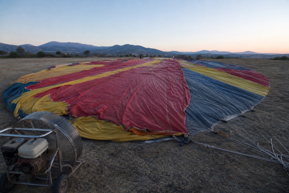 A balloon envelope laid out flat on the ground before inflation